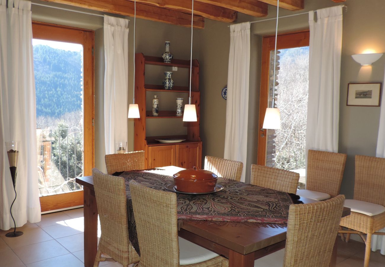 Enjoy dining elegance with a square table and scenic views in the dining room at La Bastide 48BAST